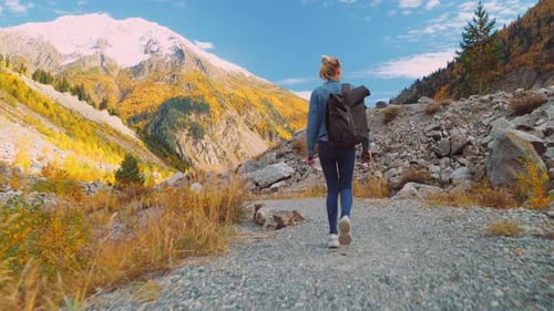 Woman Hiking on Mountain Trail in Autumn