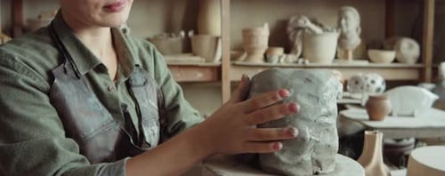 Female Sculptor Working with Clay in Studio