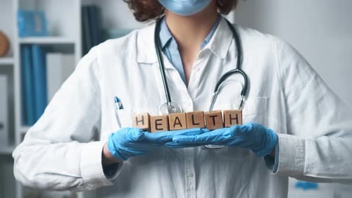 Healthcare Professional Holding Blocks Spelling Health