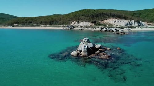 Aerial View of a Beach Turquoise Water and Huge Rocks in the Sea