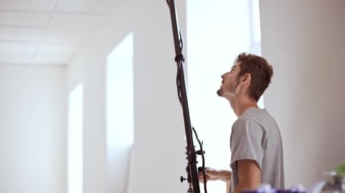 Handsome Young Man Preparing for Shooting Setting Equipment