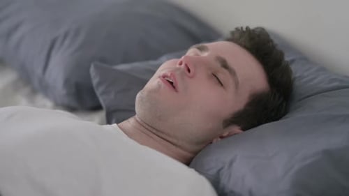 Man Sleeping in Bed Peacefully Close Up