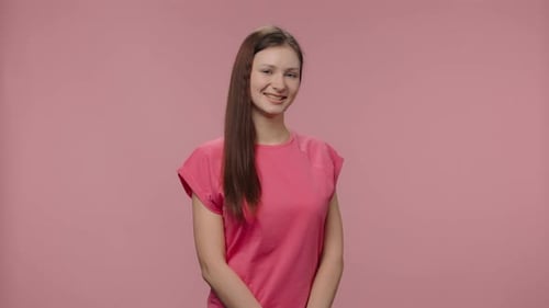 Smiling Young Woman Posing on Pink Background