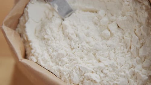 Flour in Brown Paper Bag with Spoon