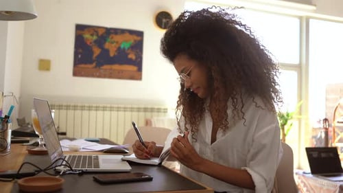 Woman Works at Laptop in Bright Home Office