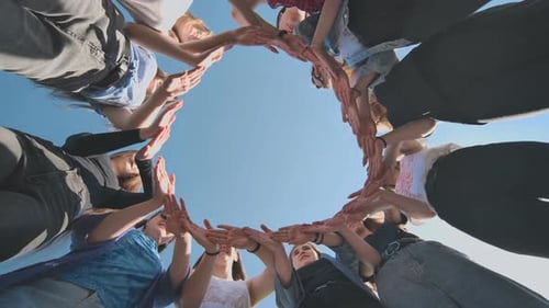 A Group of Girls Makes a Circle From Their Palms