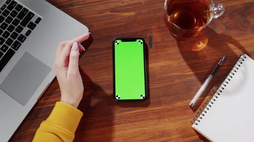 Businesswoman Using Smartphone with Green Screen Top View