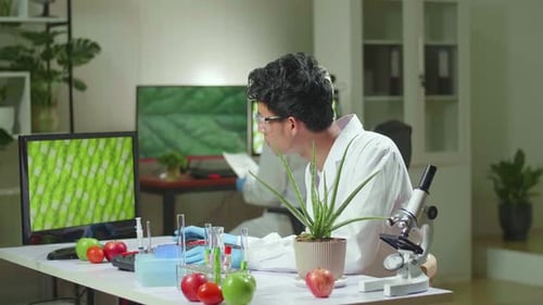 Scientist Analyzing Plant Cells in a Modern Laboratory