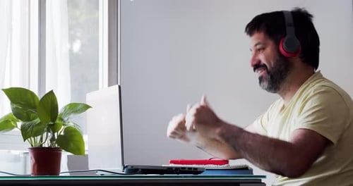 Adult Man Video Conferencing With Laptop At Home