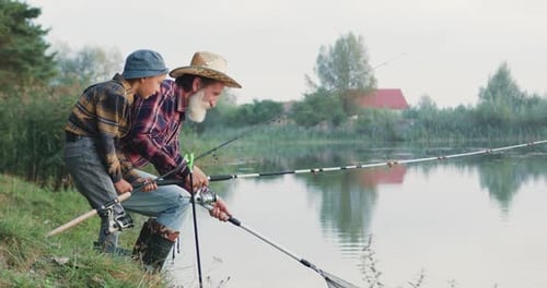 Grandfather and Child Fishing at a Quiet Lake