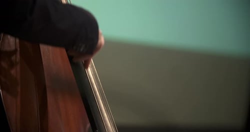 Close Up of Hand Plucking Instrument Strings