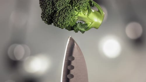Broccoli Floret Impaled on Knife Tip in Slow Motion