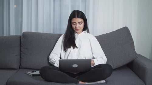 Woman Working on Laptop, Sitting on Couch