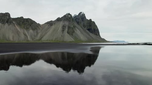 Drone Over Wet Black Sand Beach From Vestrahorn Mountain