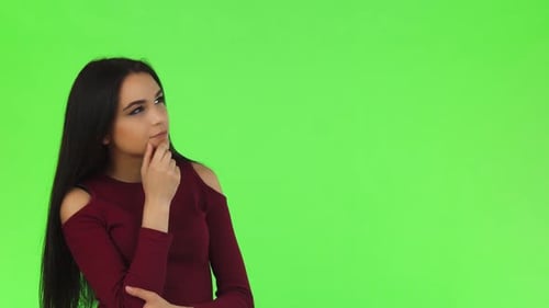Thoughtful Woman Posing Against a Green Screen