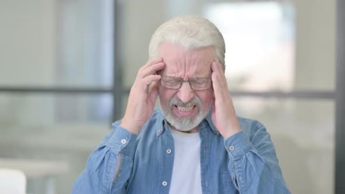Mature Man Massaging Temples Due to Headache
