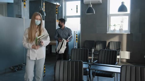 Young Diverse Group Students Classmates in Medical Masks Come Into Classroom Sit Down at Desks