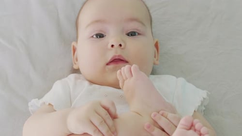 Cute Infant Playing with Their Toes