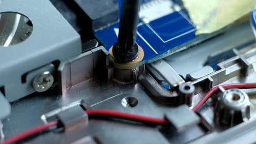 Screwdriver Tightening Screw into Computer Component