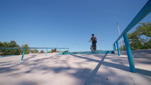 Young Adult Bike Trick in Skate Park