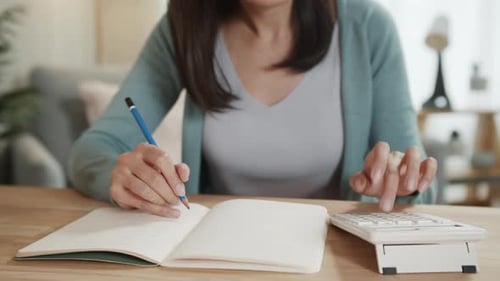 Close up of Businesswoman hand using calculating expenses tax, analysis financial data