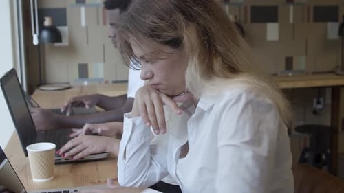 Row of Serious Freelance Workers Sitting at Counter
