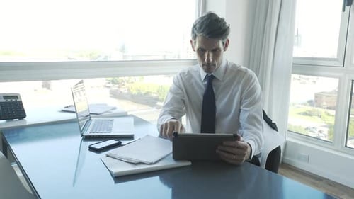 Businessman using digital tablet in office