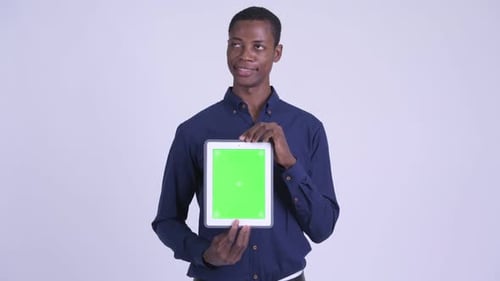 Man Holds Tablet with Chroma Key Screen