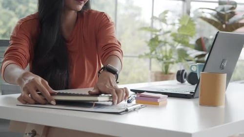Caucasian businesswoman cleaning office desk in the workplace before the lunch break.