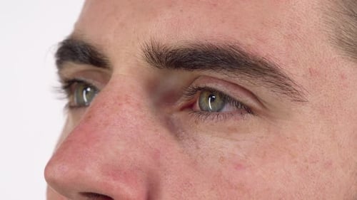 Green Eyes of a Man Looking Away Dreamily and Smiling