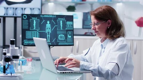 Medical Professional Working on Laptop in Bright Lab