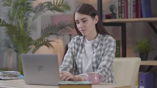 Woman Working on Laptop at Home Office Desk