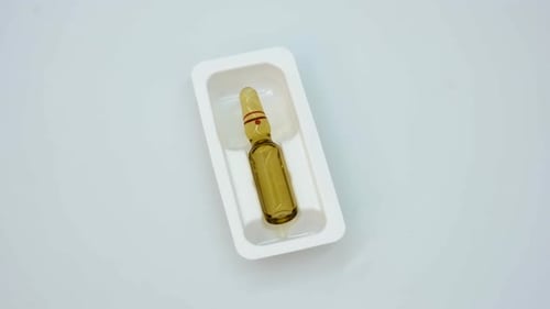 Amber Glass Medication Vial in White Container
