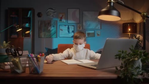 Students Return to School After COVID 19 Coronavirus Lockdown Kid Wearing a Mask Doing Homework on