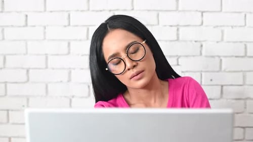 A woman sitting working a long time in office desk with neck pain, Healthy concept