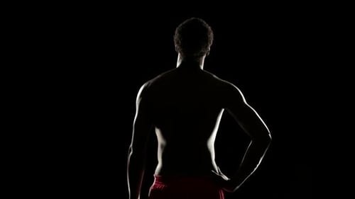 Muscular Man Silhouette Standing in the Dark