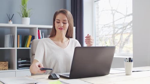 Young Woman Works at Home Office Using Computer.