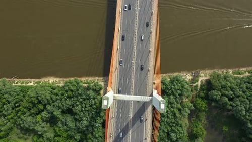 Car traffic on hanging sea bridge over bay in city view from above. Aerial View