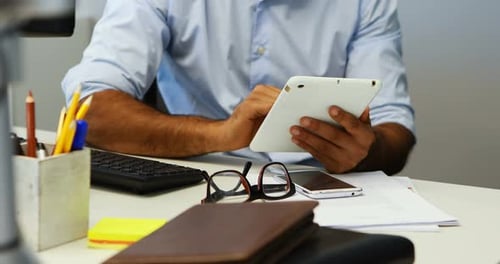 Man Using Tablet at Office Desk