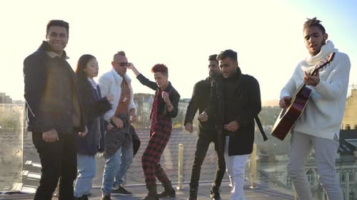 Friends Dancing and Guitar Player on Rooftop