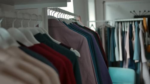 Hangers with Trendy Clothes in Shop