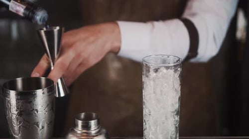 Bartender Mixing a Colorful Cocktail at the Bar