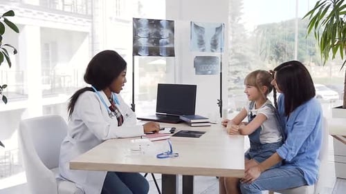Doctor Talking With Young Patient and Mother