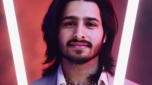 Man Smiling With Lights Behind Him