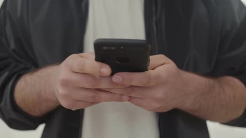 Male Hands Messaging on Smartphone