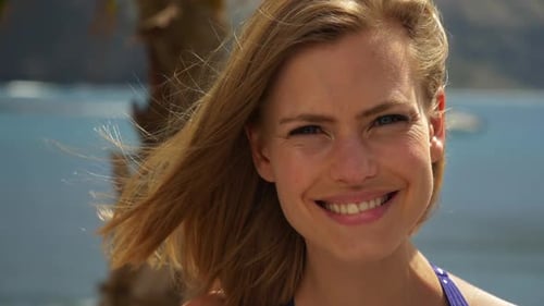 Blonde Woman Smiling on a Tropical Beach