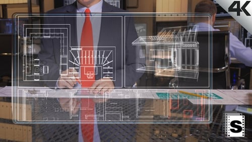 Architect Reviews Interactive House Blueprint in Office