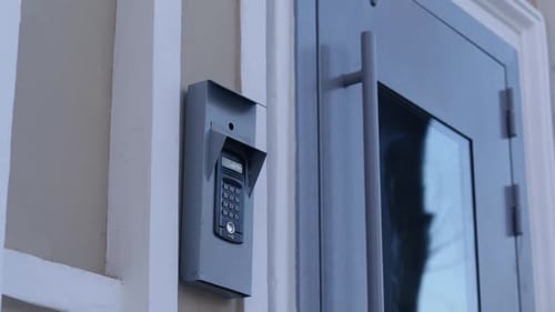 House Intercom and Closed Door with Glass at Building Enter