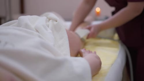 Woman Receiving Foot Massage with White Device