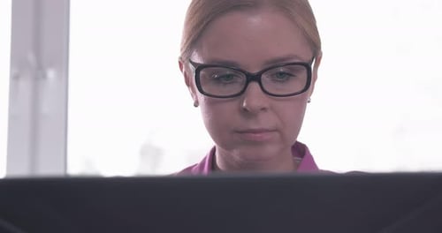 Woman Working on Computer at Desk Job